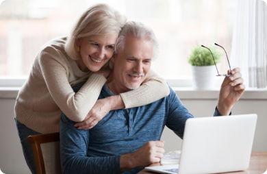 Older couple looking at their retirement savings account on a laptop